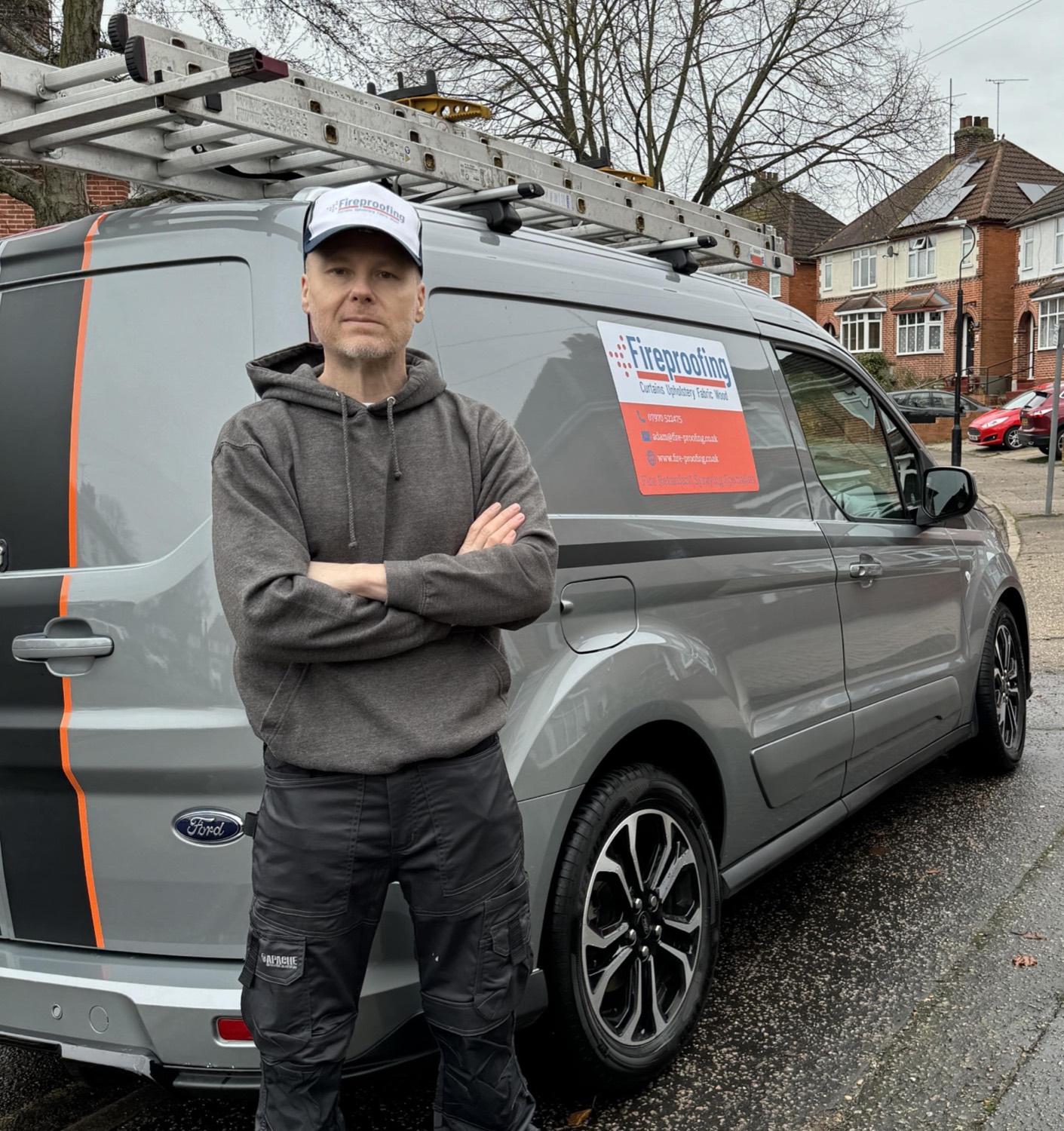 Adam Sawyer standing beside the Fire Proofing Ltd service vehicle