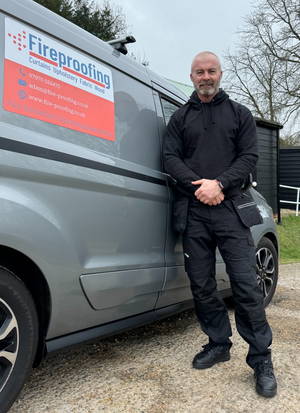 Wayne Geraghty beside the Fire Proofing Ltd service vehicle