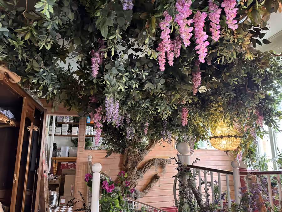 Artificial tree and hanging flowers in a hospitality venue