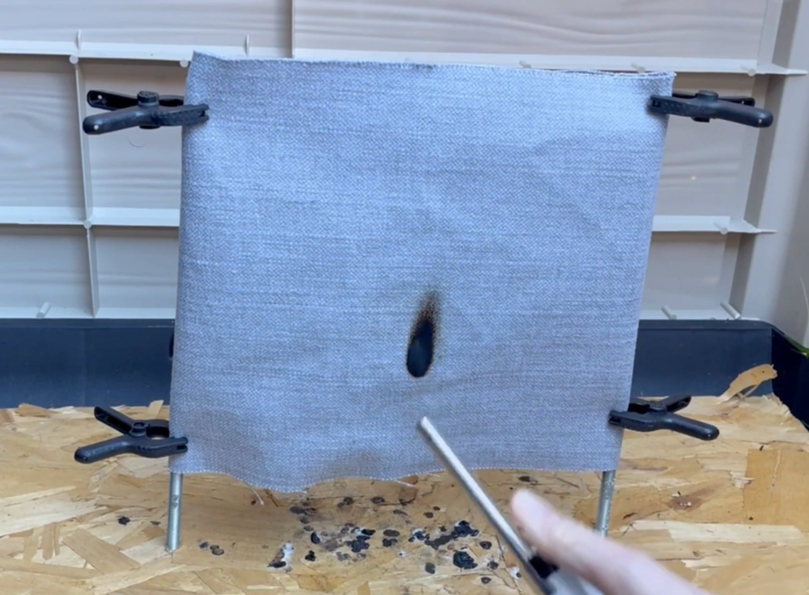 Vertical flame demonstration on treated curtain fabric