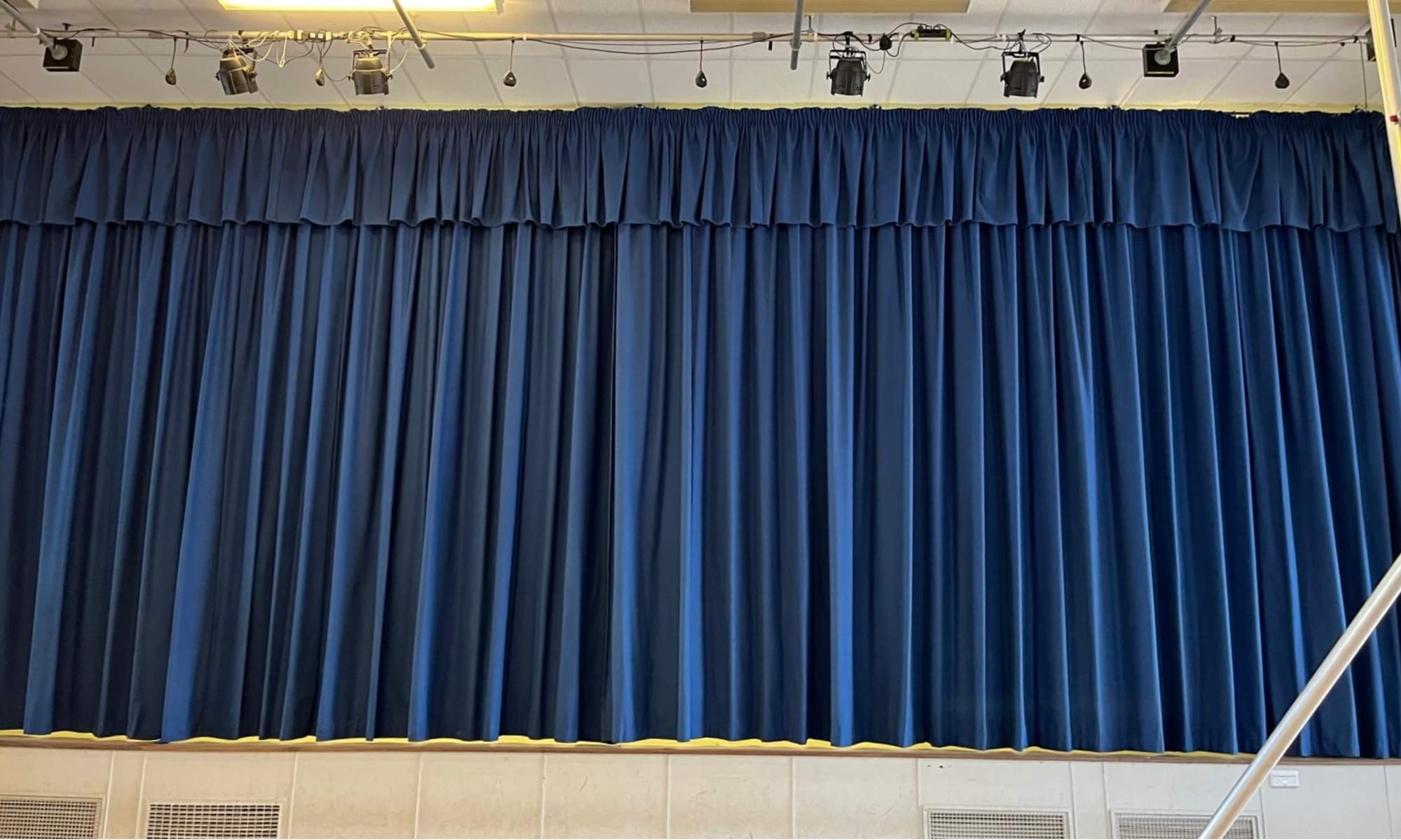 Blue stage curtains at one of the three Cornwall schools