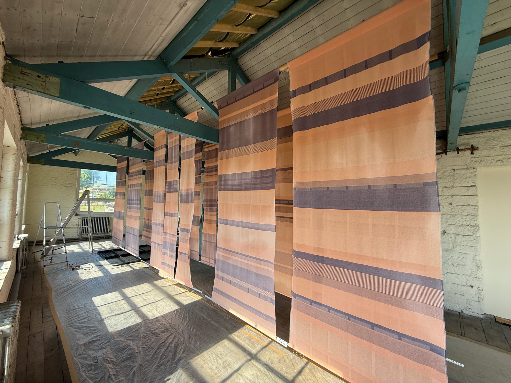 Textile fabric panels prepared for fire-retardant treatment before use as wall art
