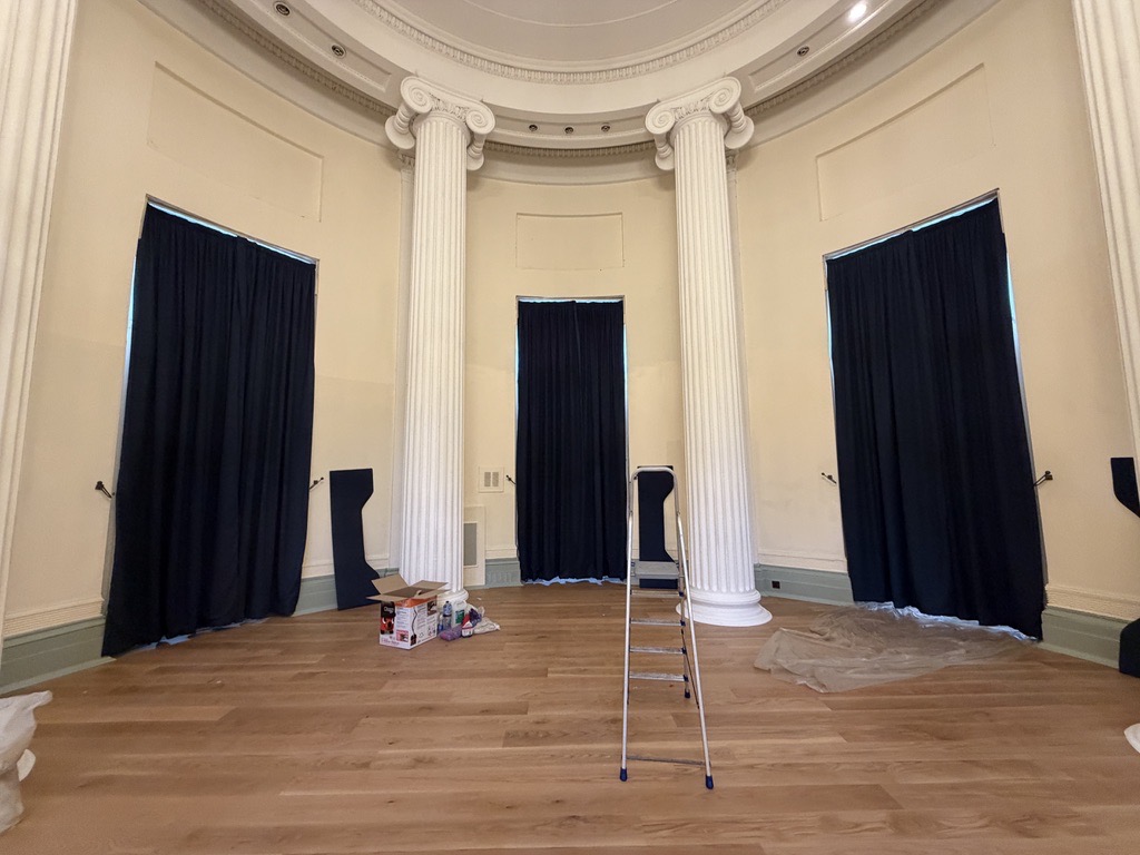 Dark curtains installed in an elegant circular wedding venue with tall columns