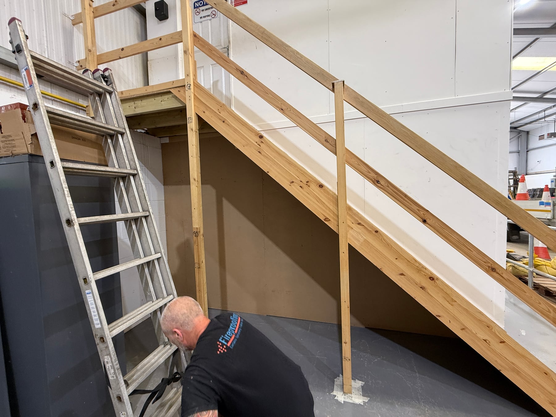 Wooden staircase undergoing a 30-minute intumescent fire-protection treatment