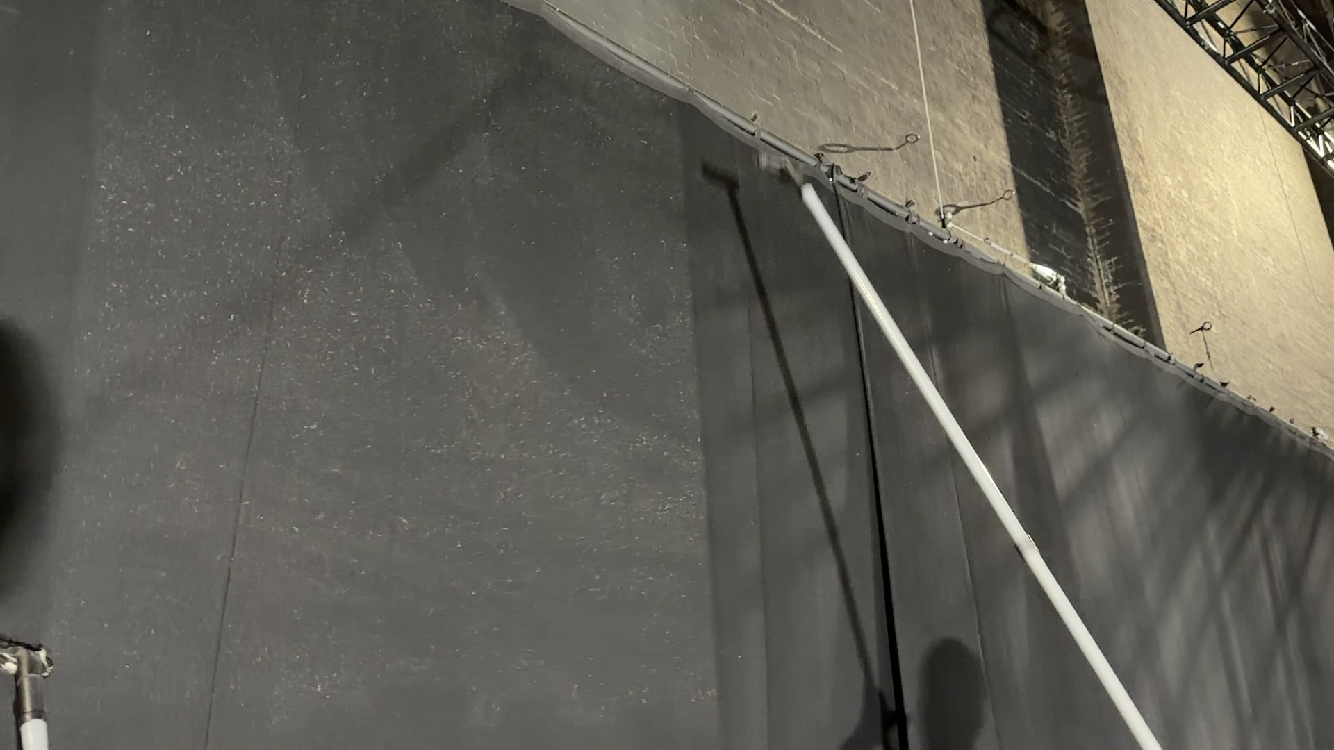 Large theatre curtains being cleaned while hanging