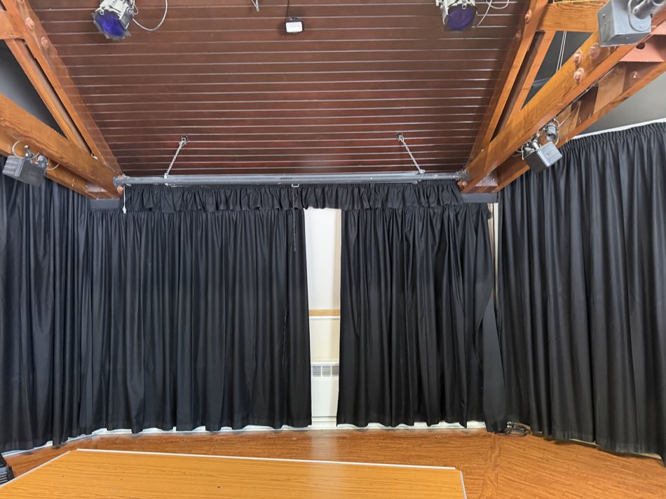 Black curtains around the stage at Epsom Playhouse