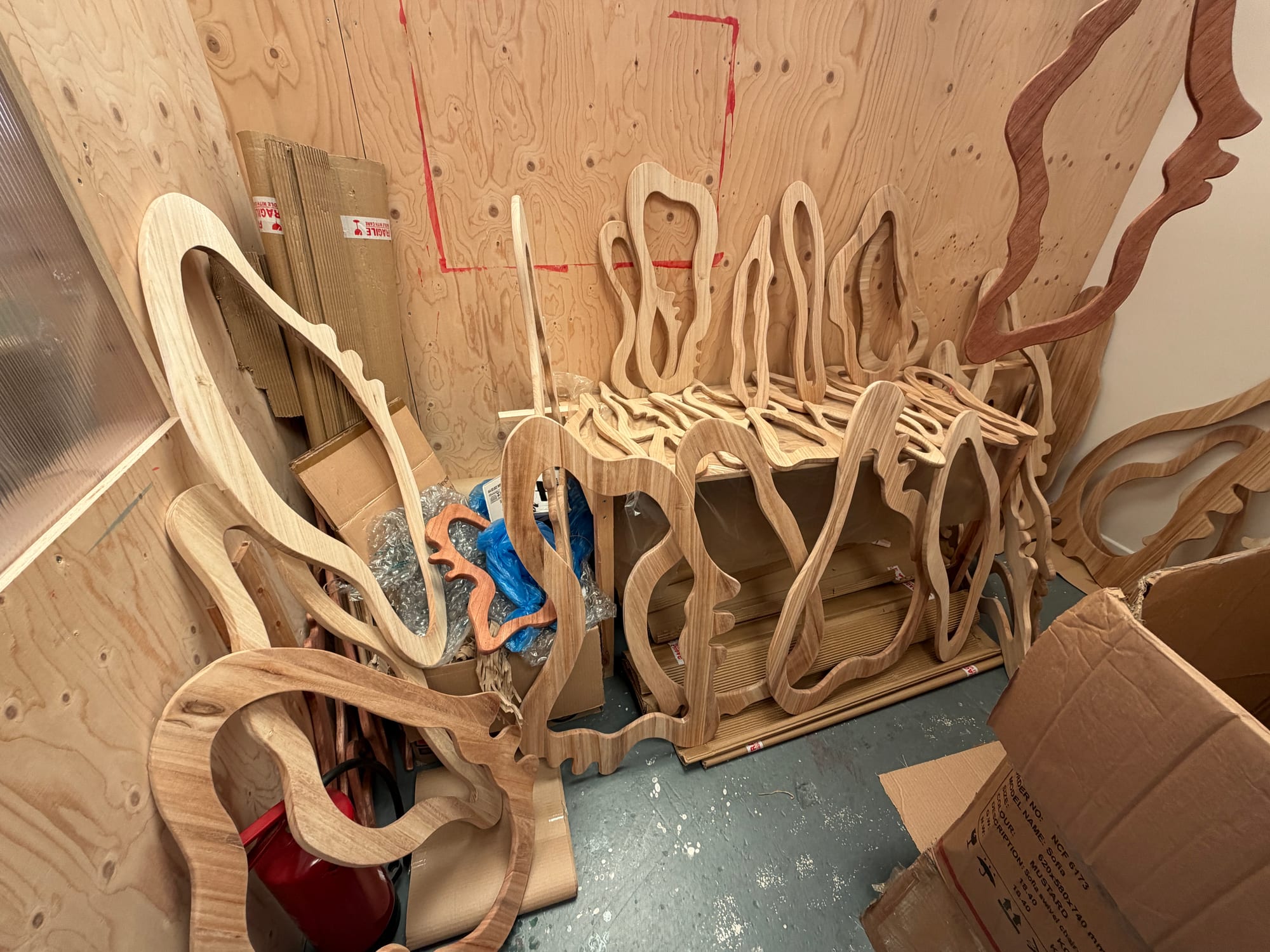 Raw shaped timber components arranged in a workshop before treatment
