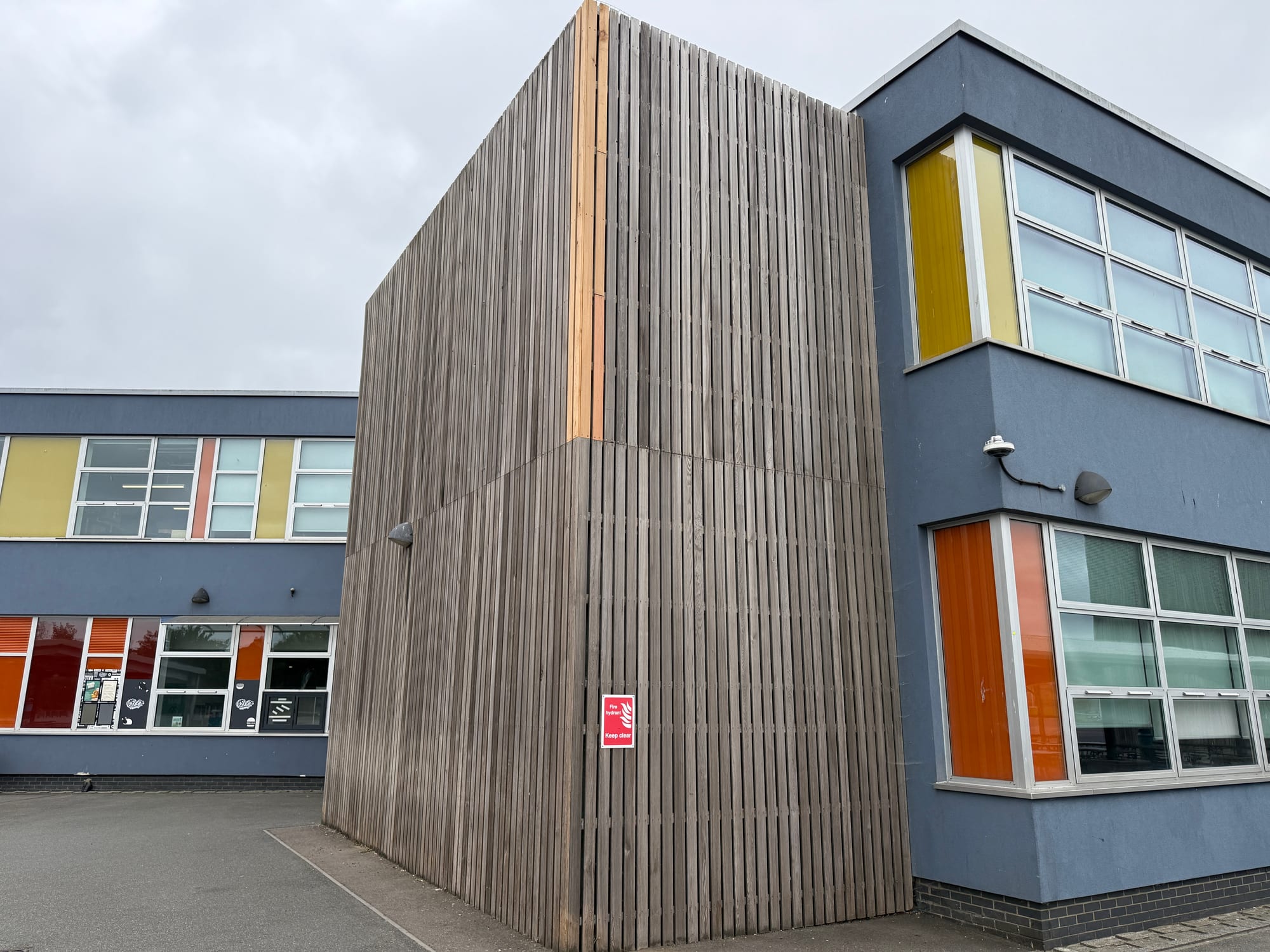 Weathered vertical timber cladding on a commercial education building