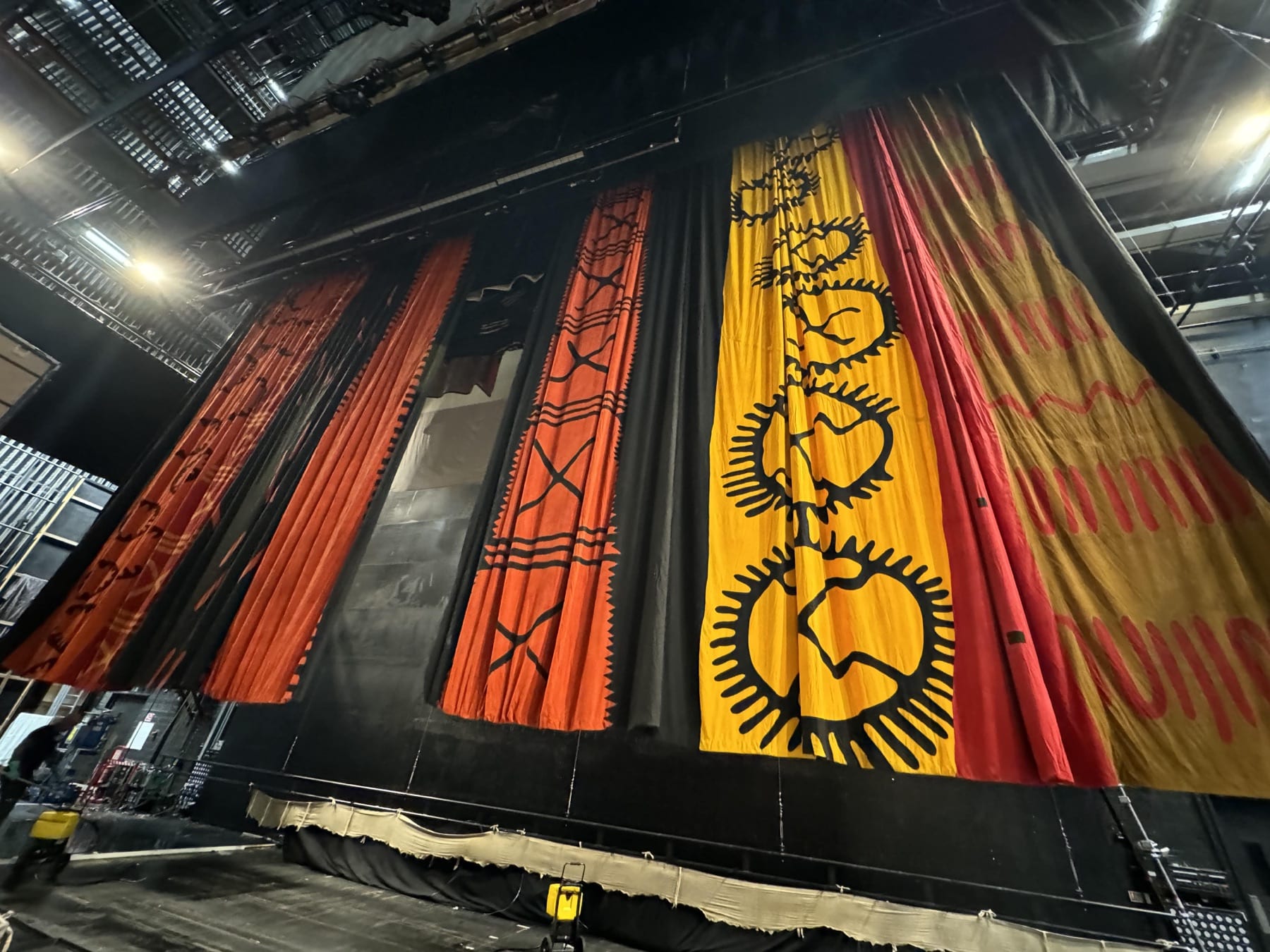 Colourful scenic backdrops hanging backstage for The Lion King