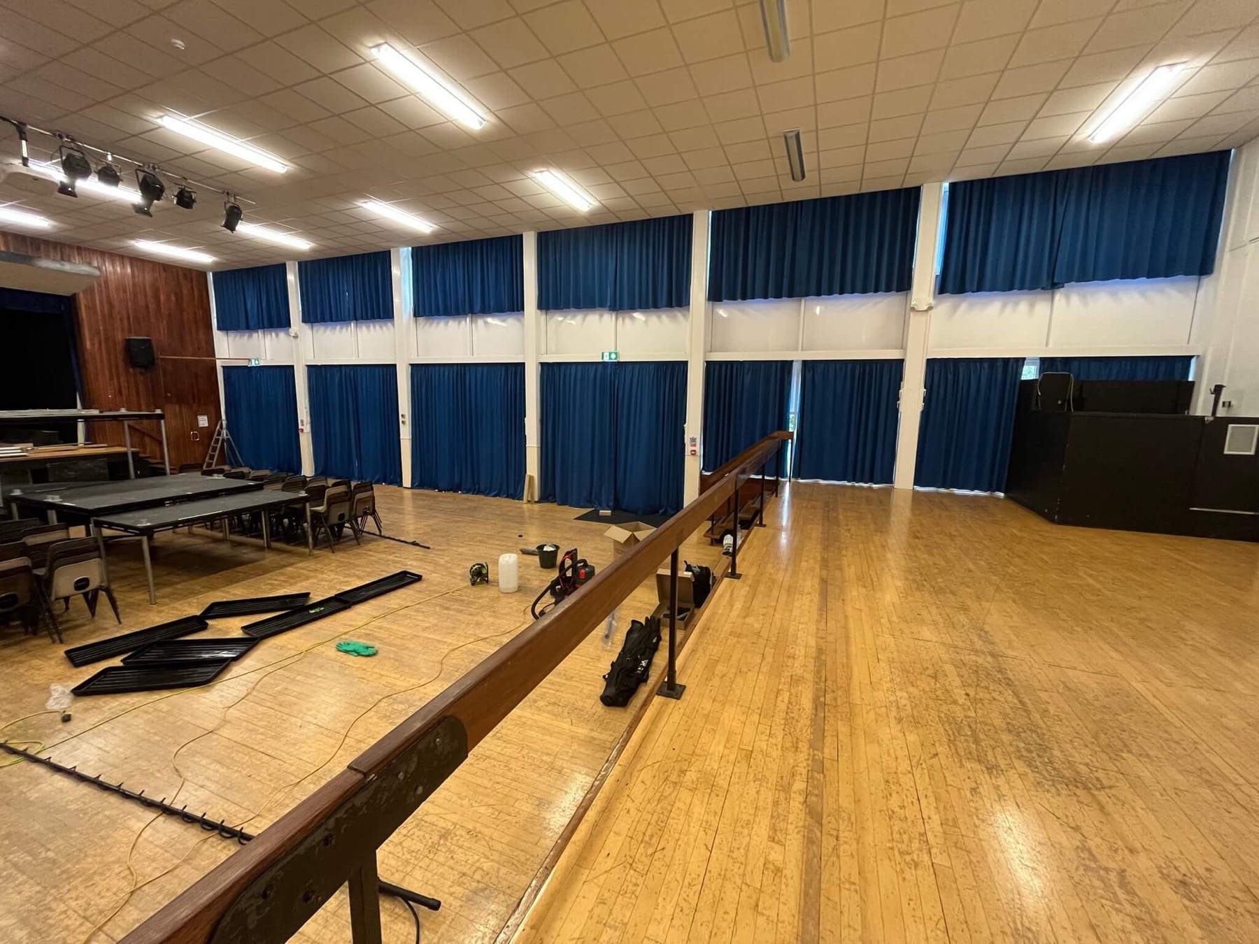Blue curtains throughout a large school hall