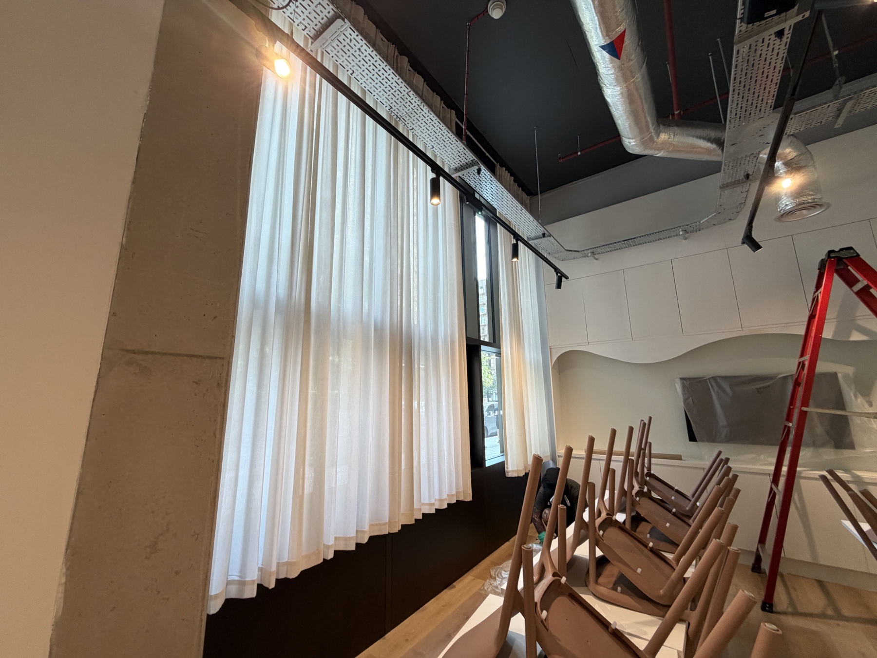 Floor-to-ceiling curtains installed during a commercial retail fit-out