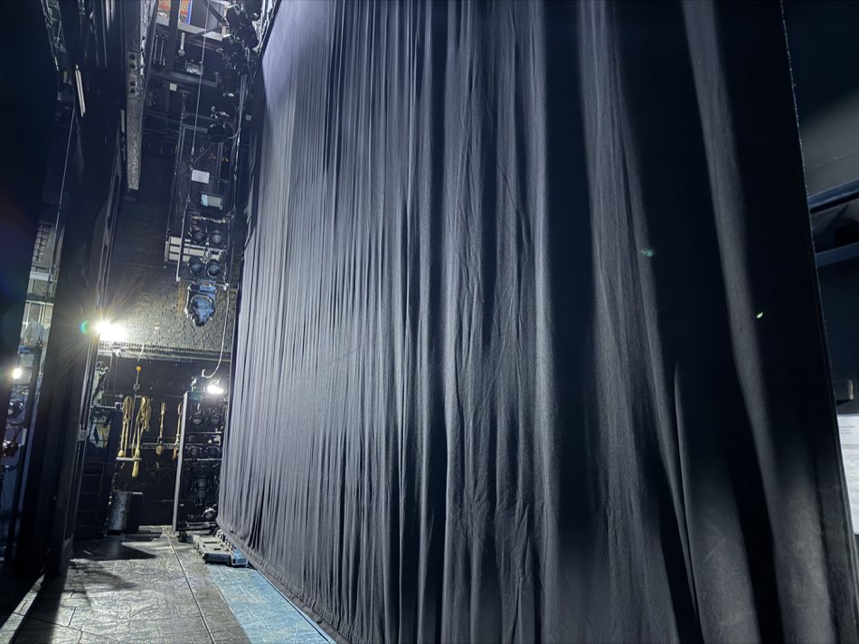 Tall black stage curtains at Sondheim Theatre