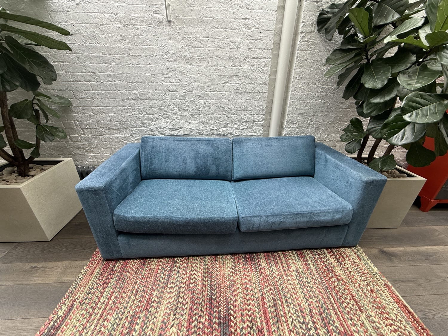Blue commercial sofa assessed for upholstery-cover treatment